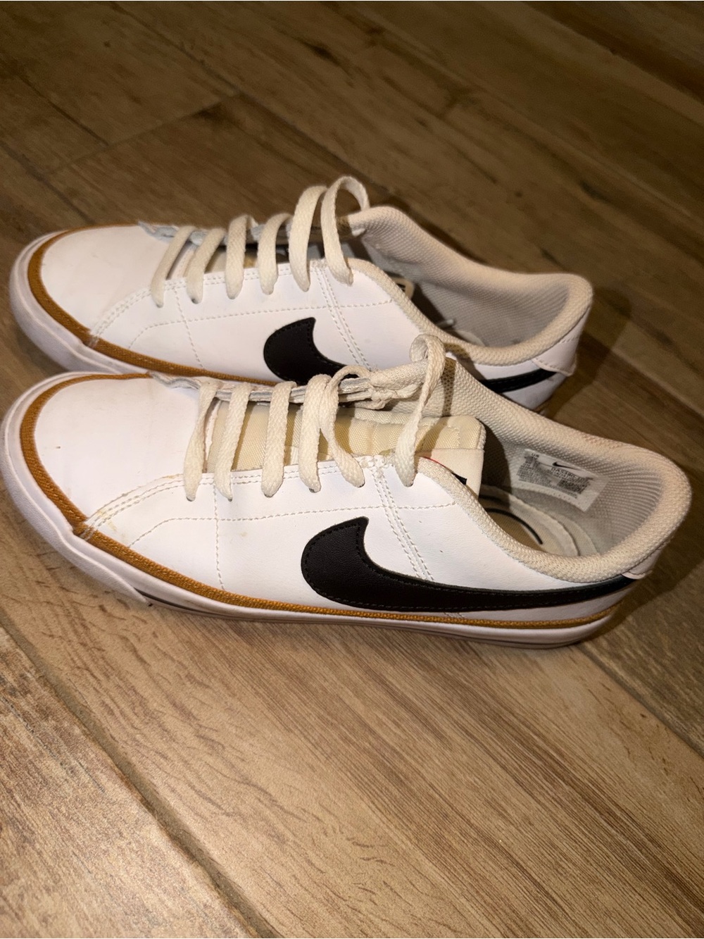 Nike White Low-Top Sneakers with Black Swoosh and Tan Trim